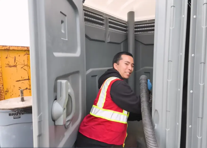 Man cleaning restroom cabins
