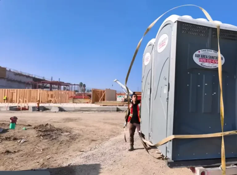 Man unloading porta potty cabins
