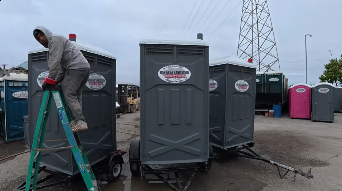 man setting restroom cabins